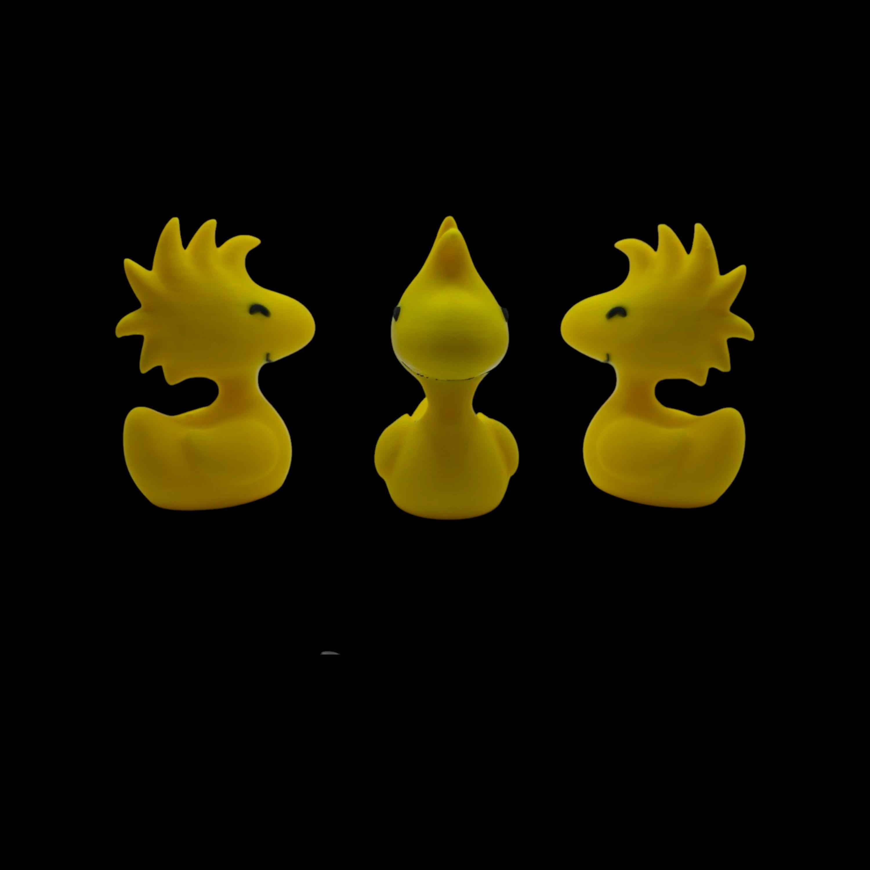 Three yellow Woodstock duck figurines are shown from slightly different angles, with the center one facing forward and the outer two facing left and right, against a black background.