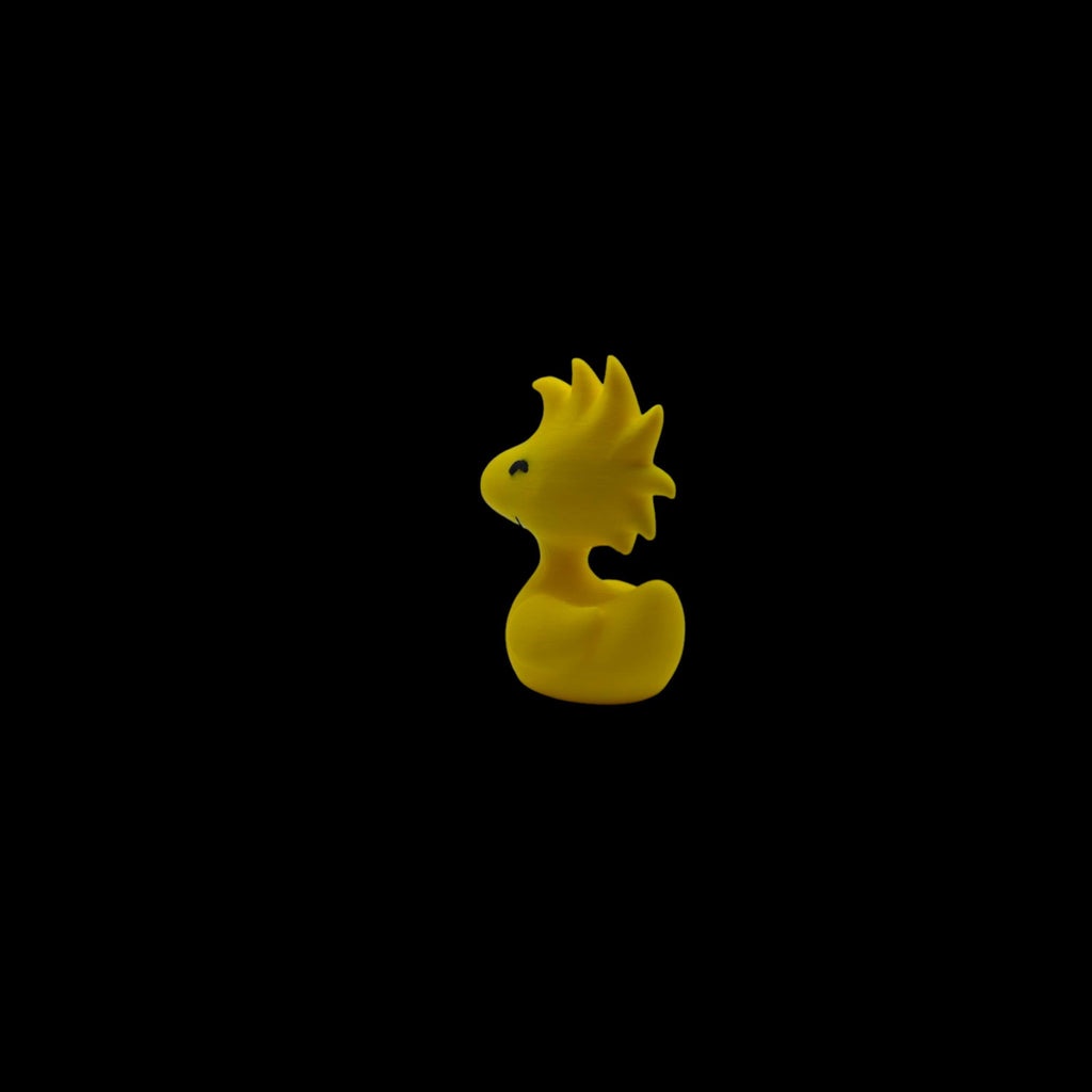 A small yellow Woodstock figurine with spiky head feathers and a small beak, facing left.